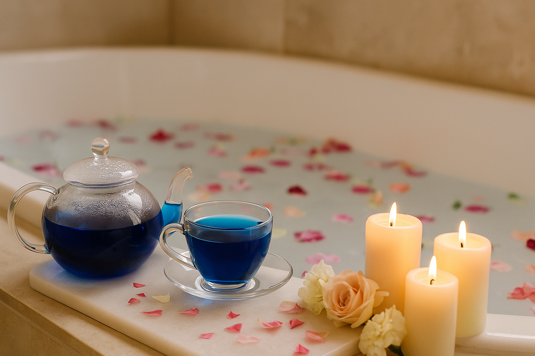 Blue Magic butterfly pea tea in a glass teapot beside a steaming bath, with candles and petals in a spa-inspired setting — capturing a serene tea ritual
