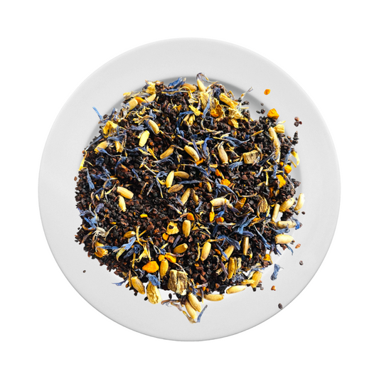 Loose-leaf Jaroma Tea Five Elements blend displayed on a white plate. A bold, coffee-like mix of roasted dandelion, chicory, turmeric, and cornflower petals. Deep, earthy tones with pops of golden yellow and blue—perfect as a caffeine-free coffee alternative.
