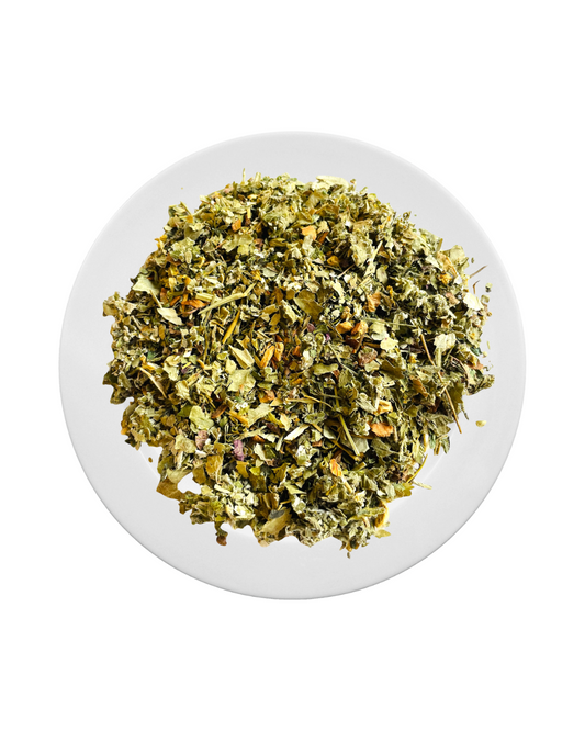 Loose-leaf Jaroma Tea Moon Harmony blend on a white plate. A soft green and golden blend of lady’s mantle, raspberry leaf, lemon balm, and nettle. Crafted to gently support hormone harmony, calm, and emotional wellbeing.