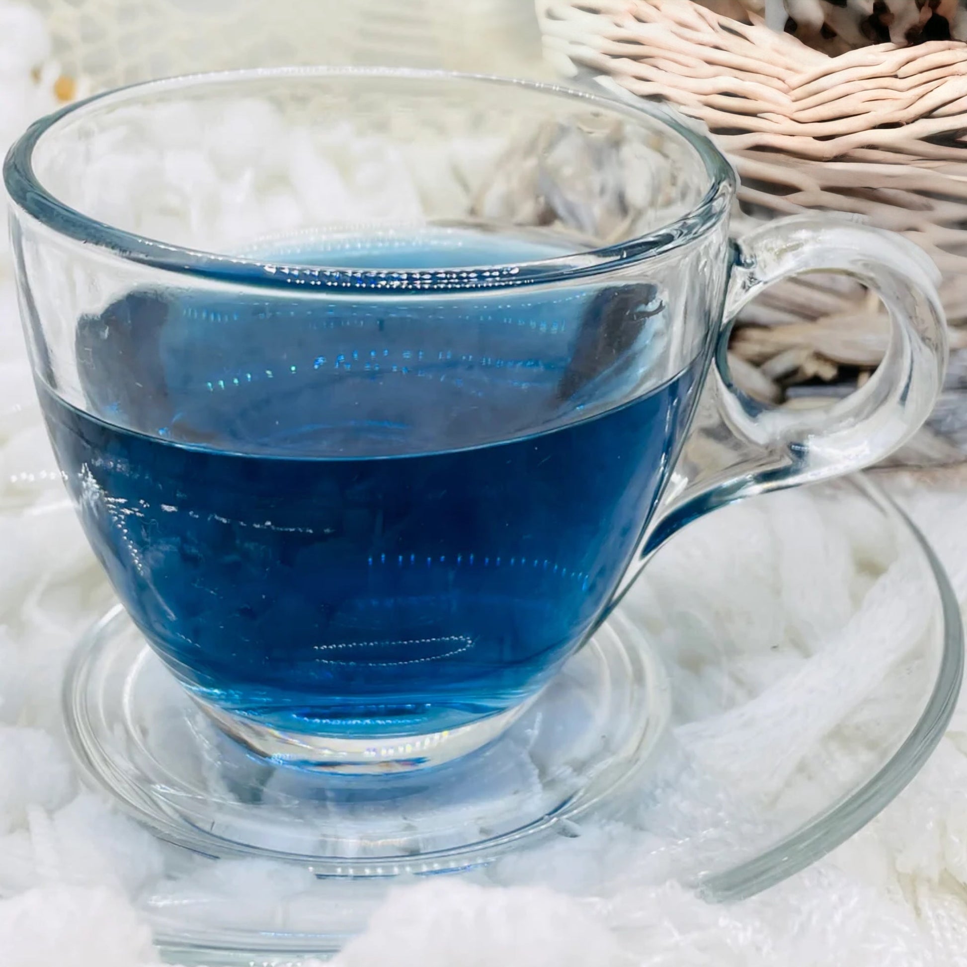 The picture is a clear glass cup of Blue Magic butterfly pea flower tea in a vivid blue colour. 