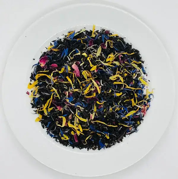 The loose-leaf blend of Jaroma's Happy Morning Earl Grey tea, showcasing a beautiful mix of organic black tea, vibrant cornflower petals, rose petals, and calendula petals. The colorful petals contrast beautifully with the dark leaves, creating a visually appealing blend that promises a fresh and fragrant tea experience, perfect for starting the day with energy and relaxation.