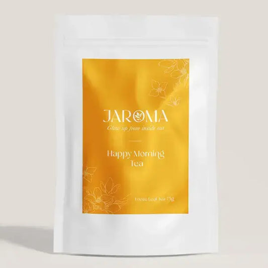 The front packaging of Jaroma's Happy Morning Earl Grey Tea, featuring a bright yellow pouch adorned with delicate floral designs. The label proudly displays 'Happy Morning Tea' in elegant font, highlighting the loose-leaf tea blend that promises a refreshing start to the day with its aromatic, energising blend of organic black tea and vibrant botanicals. 