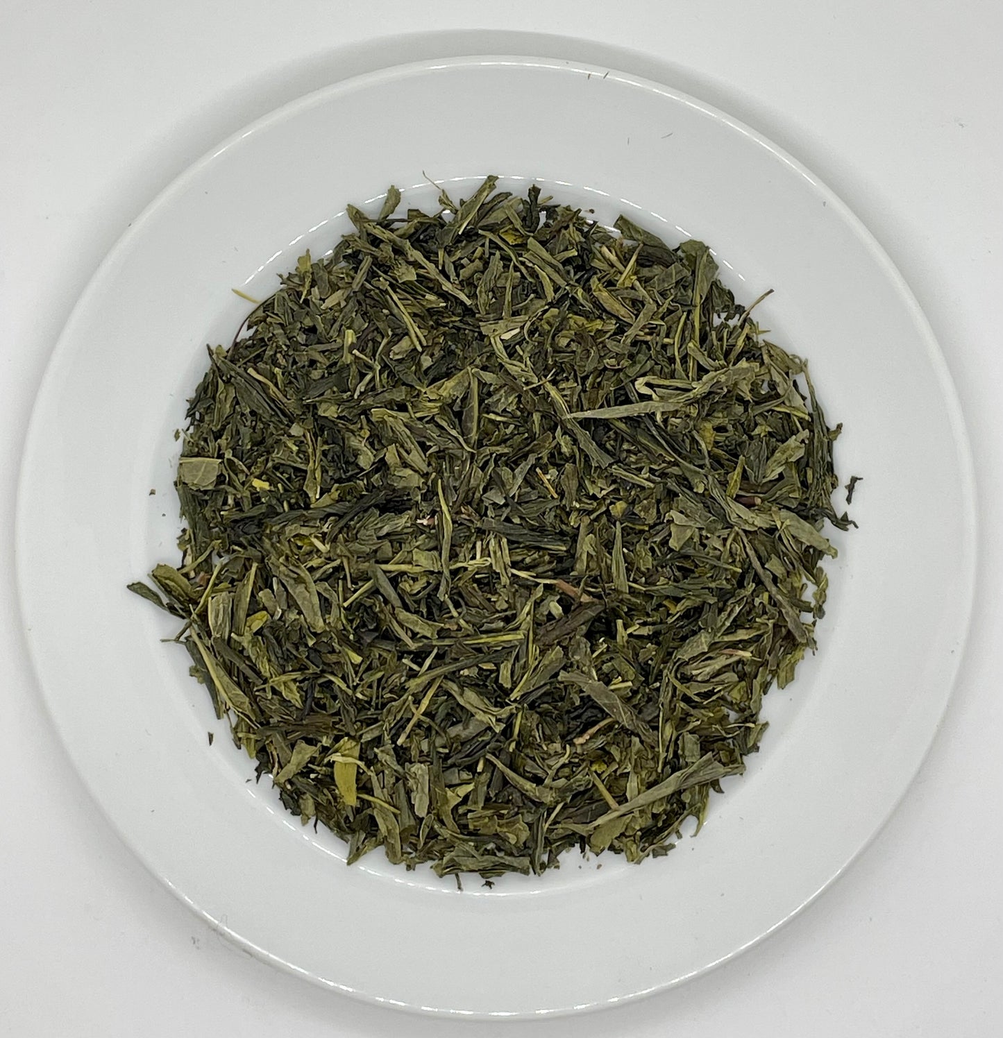 Leaves of freshly dried organic sencha green tea. 