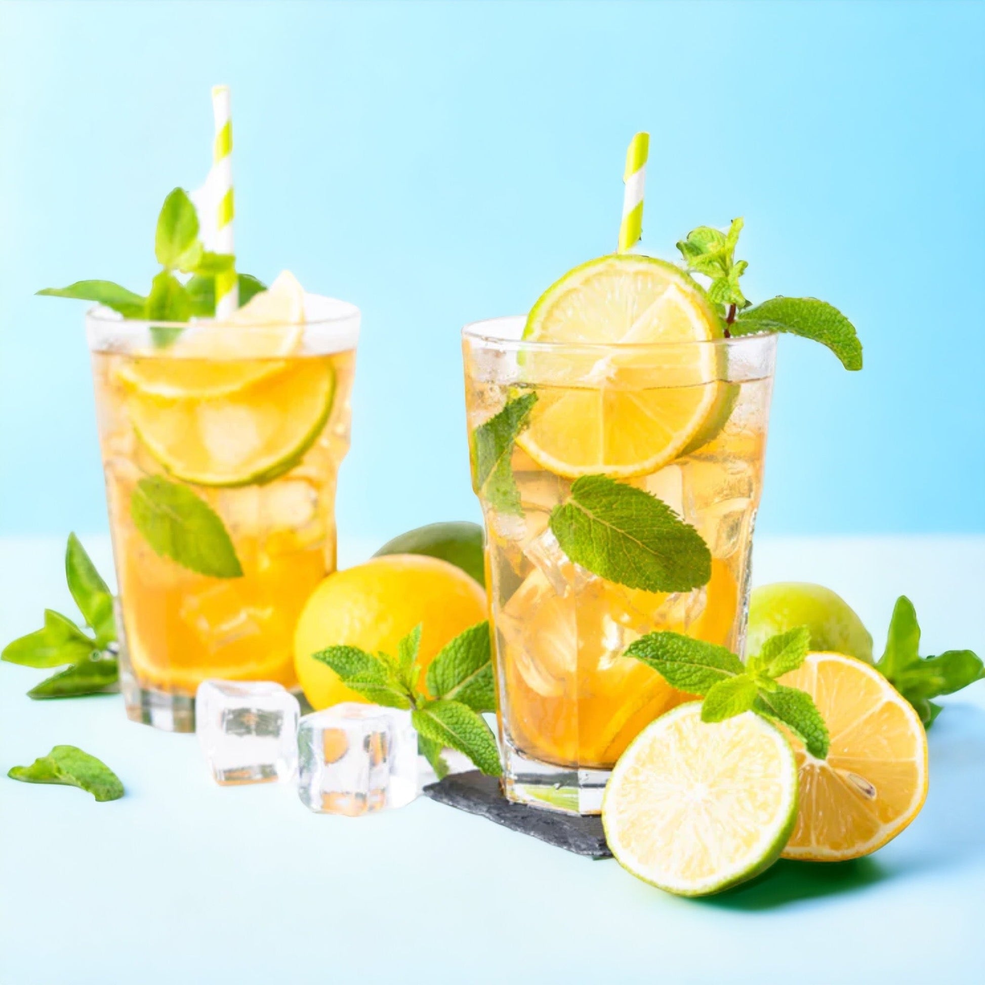 Vivid yellow  peppermint iced tea with cubes of ice and fresh mint leaves