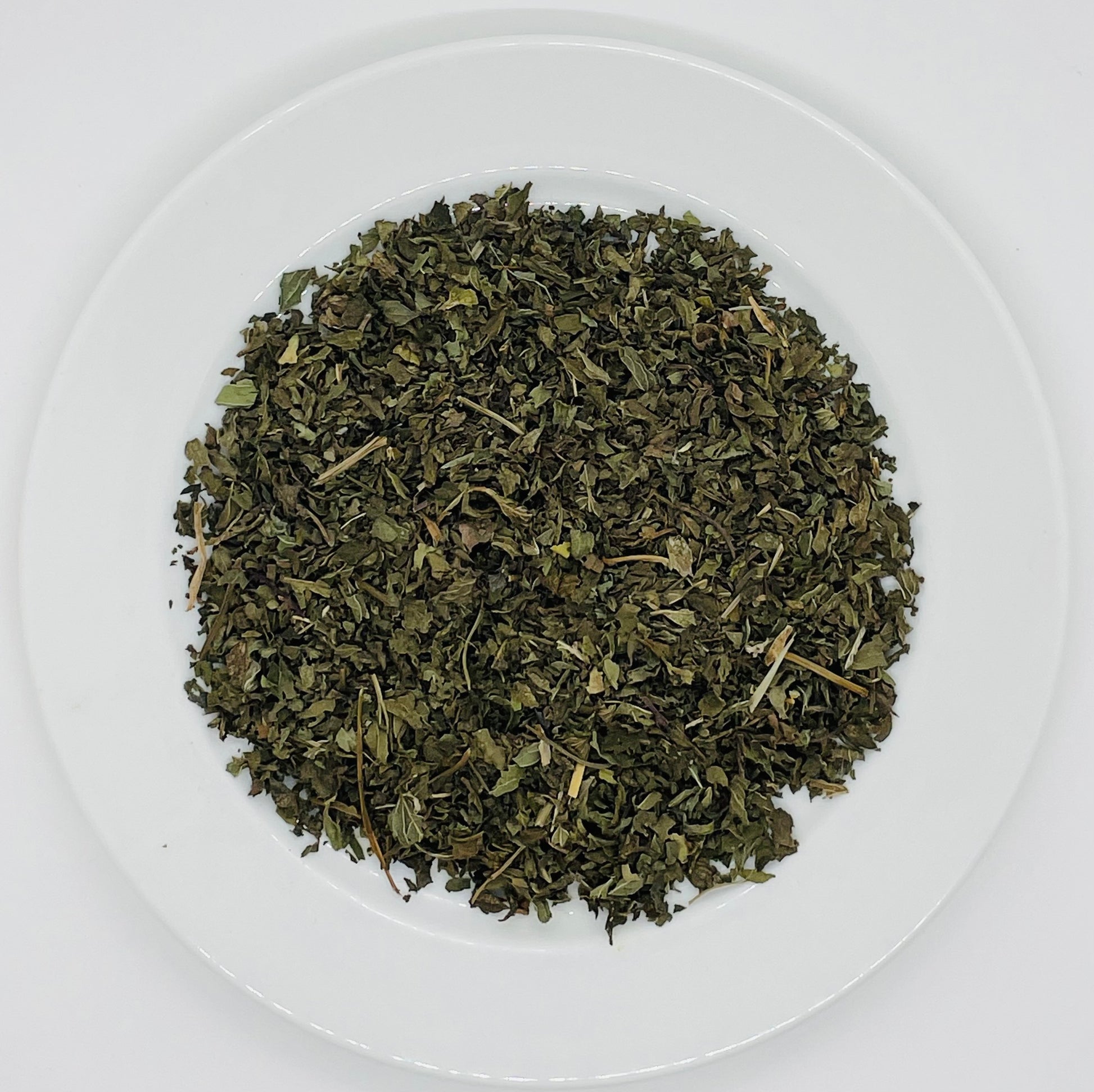 Naturally green loose leaves of dried peppermint tea.